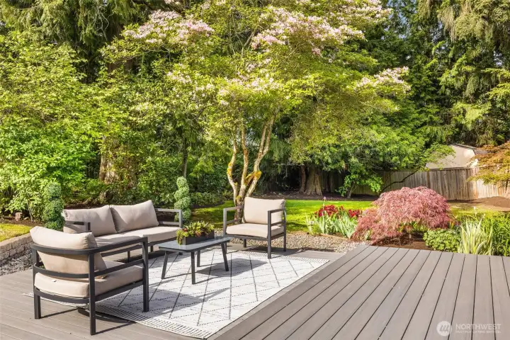 , lush landscaping, patio firepit area, and low-maintenance Timber Tech deck designed for effortless outdoor living and entertaining.