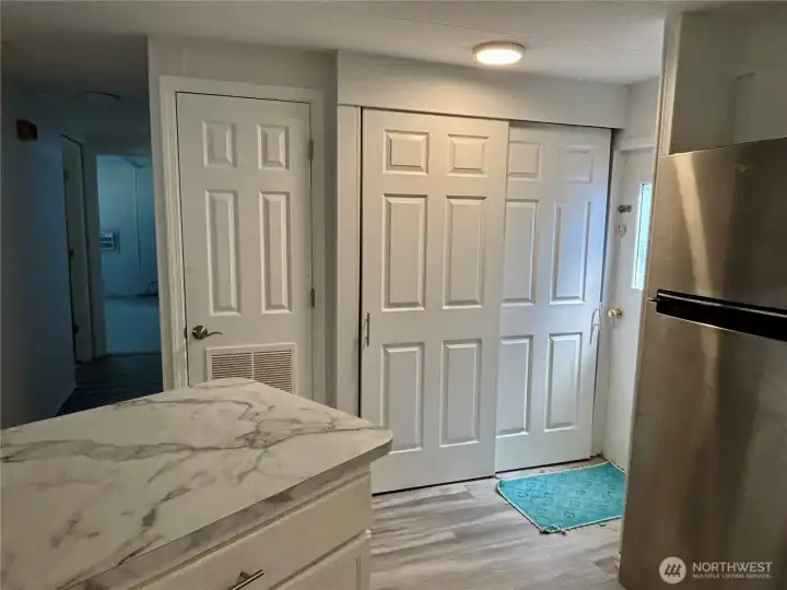 Kitchen counter, washer and dryer behind doors,