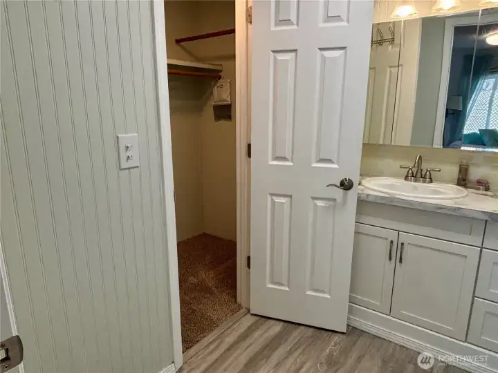 Primary bathroom looking into walk-in closet