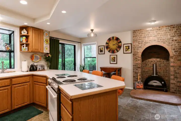 Part of the kitchen showing the brick fireplace. The insert is a pizza oven that has not been hooked up. Part of the kitchen showing the brick fireplace. The insert is a pizza oven that has not been hooked up.