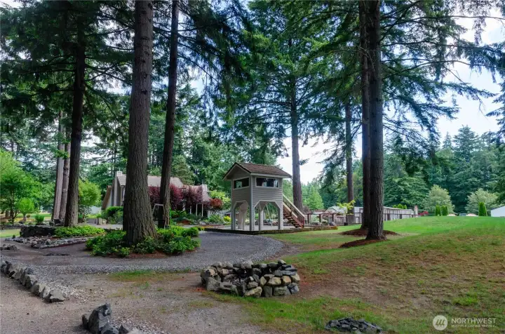 Beautiful shot showing the treehouse, playground and the back of the house Beautiful shot showing the treehouse, playground and the back of the house
