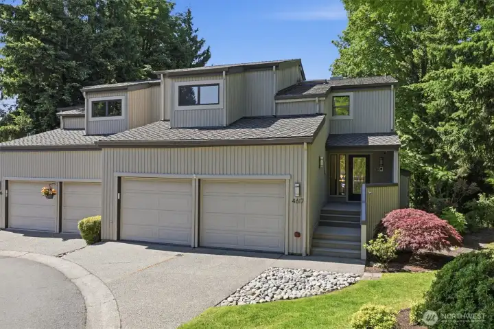 Private end-unit setting featuring attached two-car garage, contemporary architecture, and a welcoming covered entrance. Private end-unit setting featuring attached two-car garage, contemporary architecture, and a welcoming covered entrance.
