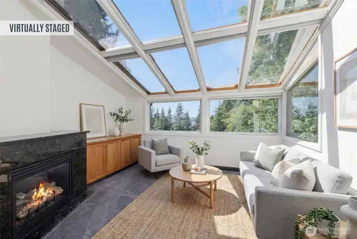Virtually staged. Spectacular sunroom featuring floor-to-ceiling windows, vaulted glass ceiling, gas fireplace, and serene treetop views that bring the outdoors in. Virtually staged. Spectacular sunroom featuring floor-to-ceiling windows, vaulted glass ceiling, gas fireplace, and serene treetop views that bring the outdoors in.