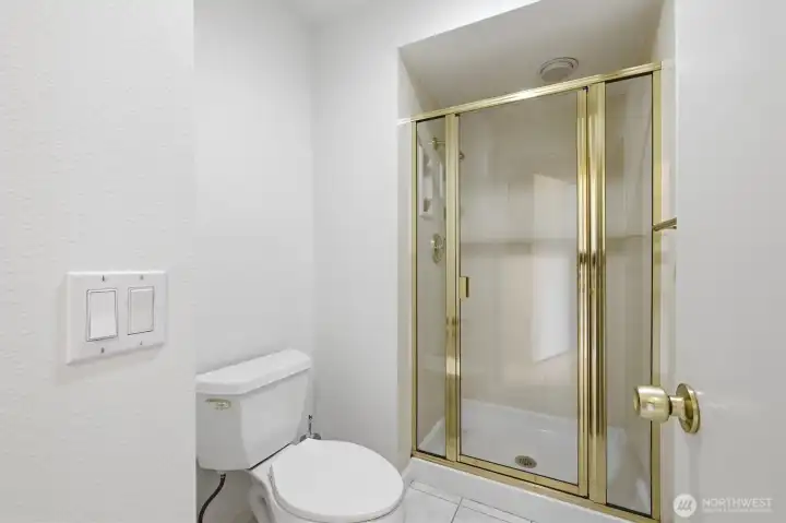 Private walk-in shower with glass enclosure conveniently positioned within the expansive primary bath suite. Private walk-in shower with glass enclosure conveniently positioned within the expansive primary bath suite.