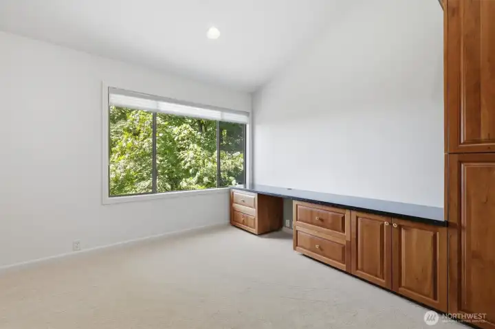 Dedicated home office featuring custom built-ins, generous workspace, and tranquil treetop views that create an ideal work-from-home environment. Dedicated home office featuring custom built-ins, generous workspace, and tranquil treetop views that create an ideal work-from-home environment.