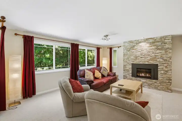 Cozy family room with gas fireplace, outlook to greenbelt Cozy family room with gas fireplace, outlook to greenbelt