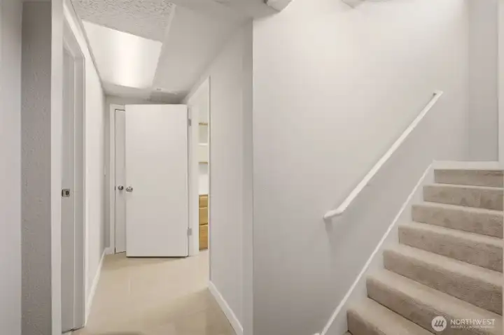 Stairs leading to the first floor, direct garage access from here