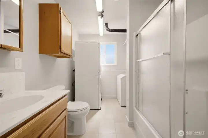 Washer and dryer includes a garment steamer