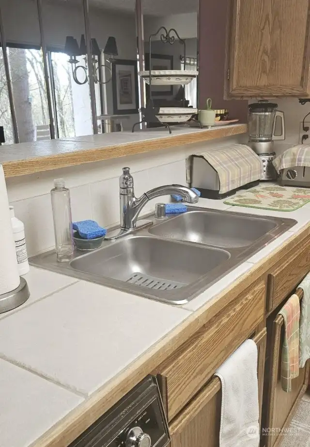 Double sinks and open to the living room.