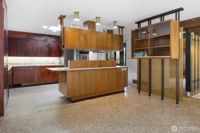 Suspended kitchen cabinets subtly define the kitchen space while built-in storage enhances functionality.