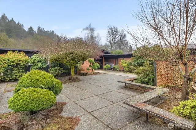 Relax and take in the verdant surroundings from one of the elegantly simple courtyard benches.