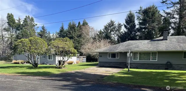 A beach home, cottage and shop on over a half-acre, beautifully landscaped with easy flora.