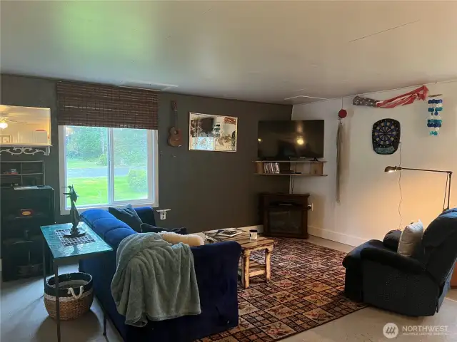 Sharing the same space as the kitchen is very comfortable living room with electric fireplace that heats the room.