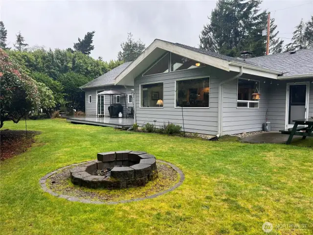 Backyard has a firepit.  Deck and newly added dining room.