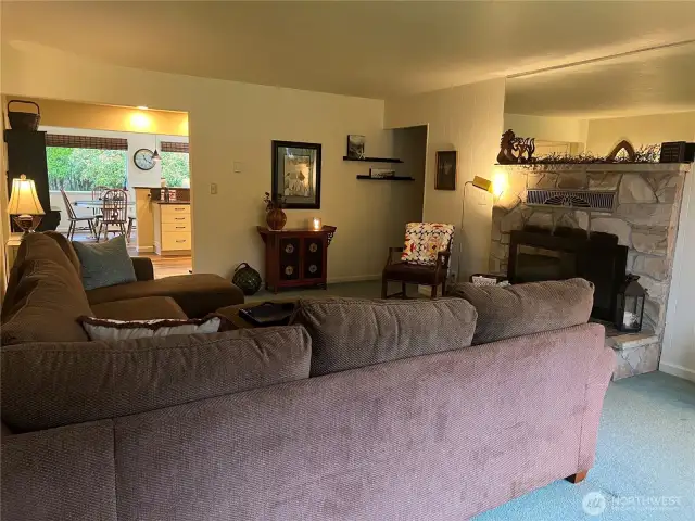 Living room leads to the Kitchen on left and the rest of the house on the right.