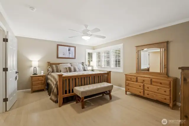 Spacious primary suite with ceiling fan