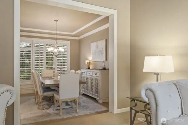 Formal dining. Wood shutters and custom window treatments throughout