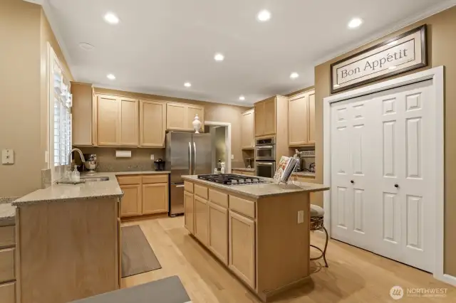Kitchen features Island breakfast bar + gas cooktop, all stainless steel appliances and quartz countertops