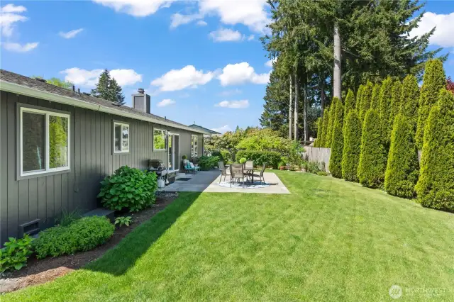 Step into your own private retreat with this expansive, fully fenced backyard featuring a spacious 24' x 17' concrete patio—ideal for dining al fresco, entertaining, or simply enjoying the serene outdoor setting. Lush greenery and mature privacy trees create a peaceful escape right outside your door.