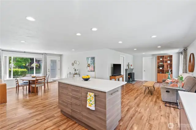 Open-concept living at its finest—enjoy seamless flow from the kitchen island to the living and dining areas, all enhanced by recessed lighting, stylish finishes, and beautiful wide-plank flooring.