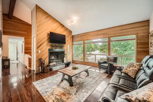 Vaulted Ceilings and large windows with a fireplace