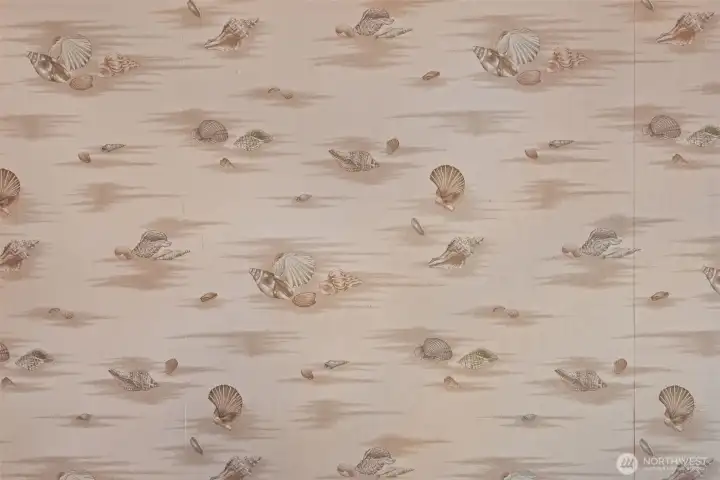 Every detail tells a story — even this seashell wallpaper, original to the home since 1995.