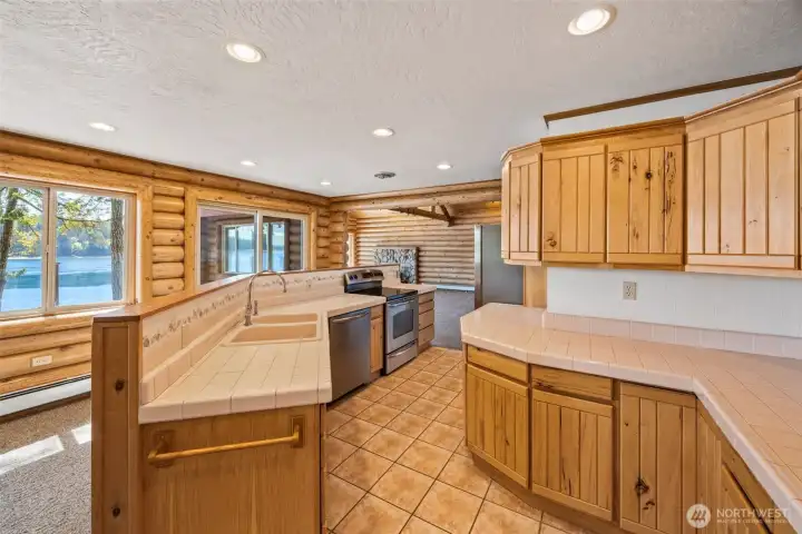 An open kitchen designed with function + comfort in mind, complete with an eat-in nook.