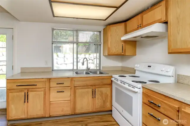 Spacious kitchen looks out to yard