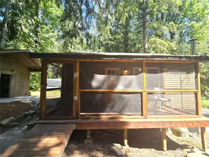 Very convenient covered and screened front porch. Gently sloping ramp allows you to avoid any steps.