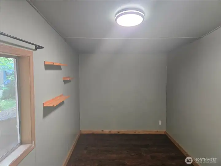 The second bedroom has new flooring and custom shelving.