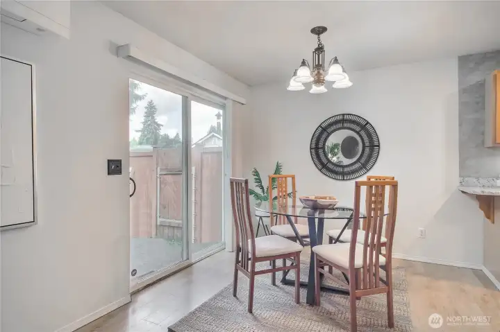 The dining area off the kitchen opens directly to the backyard creating a seamless flow for indoor-outdoor living.