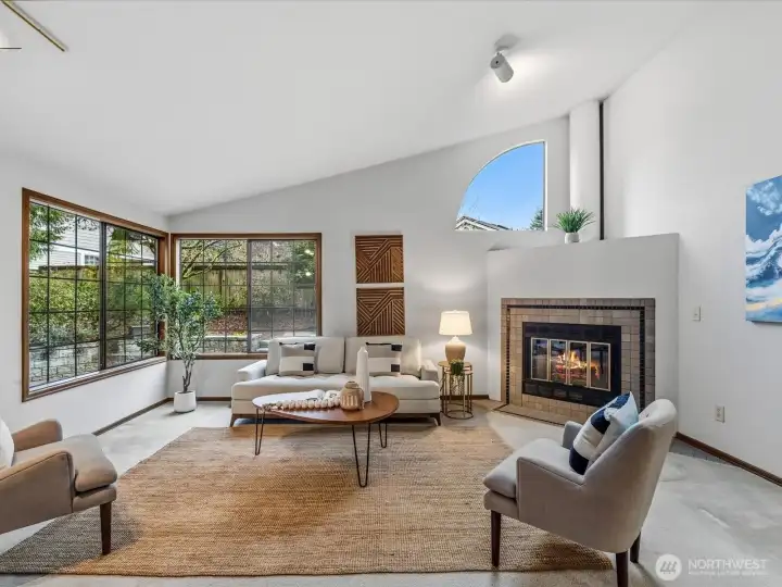 Spacious bright, inviting living room full of windows and with vaulted ceilings