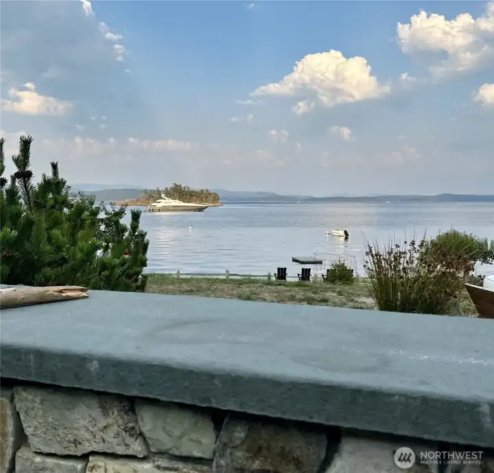 In addition to the mooring buoy, Rocky Bay offers safe anchorage for larger vessels too.  Just beyond the property's mooring buoy is the yacht, Lady L (147 ft).  She sat at anchor for 3 days. O'Neil Island in the background.