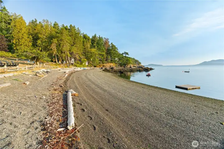 Beach at low tide. The tide swing is typically 2ft to 8ft.  Approximately 330 lineal feet of pebble beach offers gentle landings for boats, paddle boards, kayaks and swimmers.