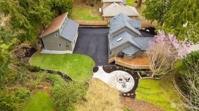 Aerial showing large lot, main house, detached garage with studio/MIL, new fire pit & patio. Nice landscaping.