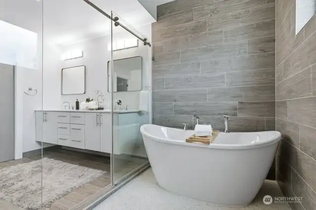 Spa like bath features heated floors, tub and sumptuous shower room wrapped with tile walls