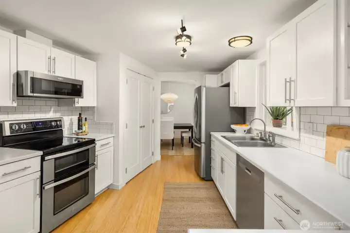 Light and bright kitchen with newer stainless appliances.