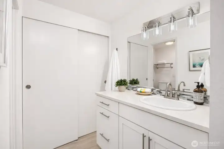 Primary ensuite bathroom. All doors and trim throughout house recently painted and new lighting installed in both primary and second bathrooms.