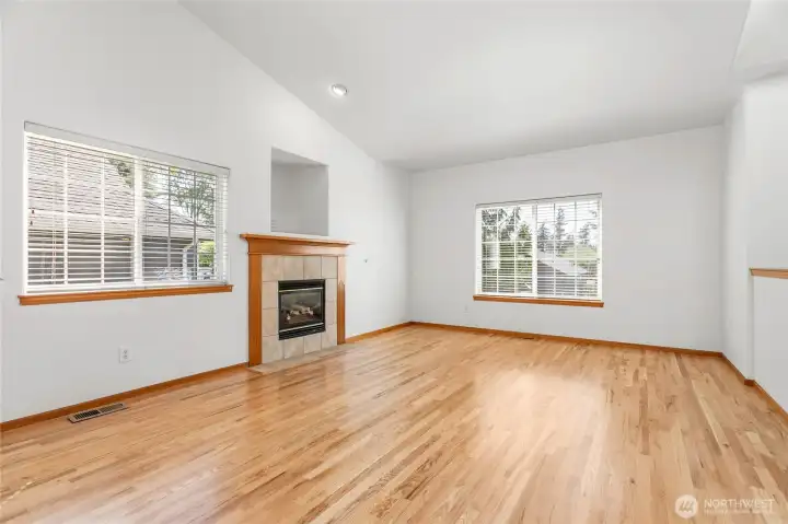 Living room features newly refinished hardwood floors throughout main living area, fresh paint and a gas fireplace making this space the centerpiece for gathering