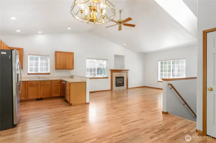 From the front entry, you step into the main living area with an open concept kitchen, dining and living rooms, with vaulted ceilings, new paint and refinished hardwood floors