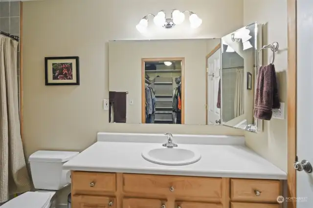 Primary Bathroom also houses Large Walk In Closet with Melamine Shelves for Storage