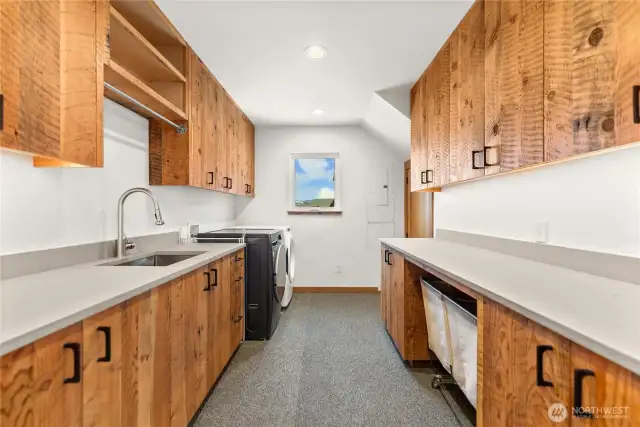 Even the spacious laundry room boasts custom reclaimed wood cabinets!