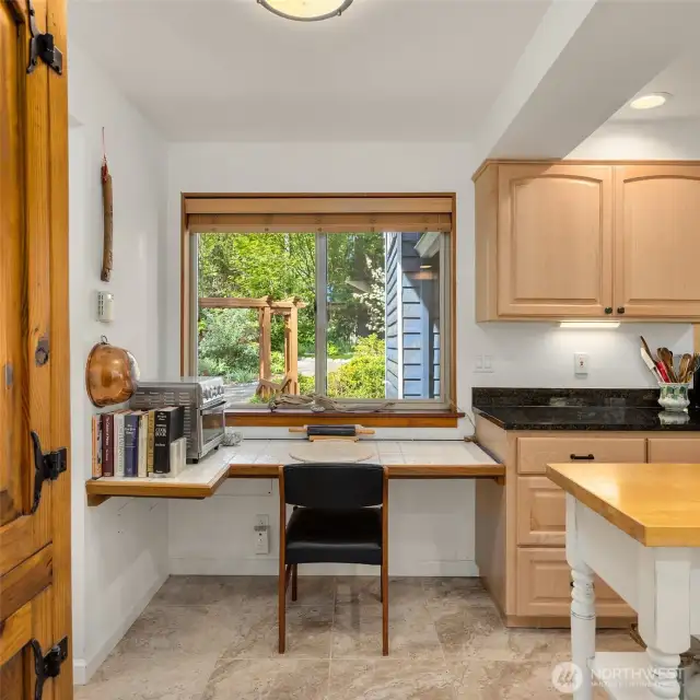 The kitchen includes a thoughtfully designed desk nook.