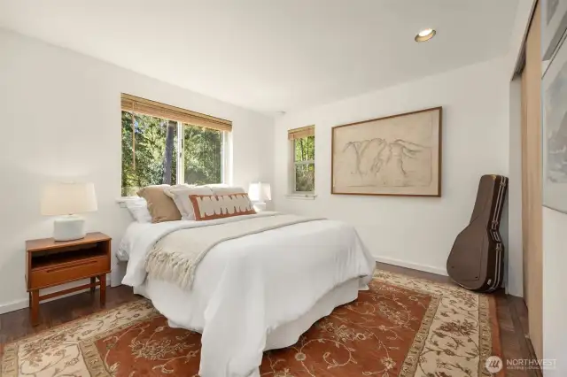 Guests will feel right at home in either of the two charming main-floor bedrooms, which share a stylishly updated bathroom. Perfect for hosting with ease, the layout ensures privacy while maintaining a warm, connected feel.