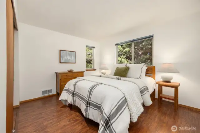 Located on the main level, two bright and airy guest bedrooms provide flexible space for family, friends, or a home office setup. A shared full bath is conveniently positioned between the rooms, making this wing of the home both practical and inviting.