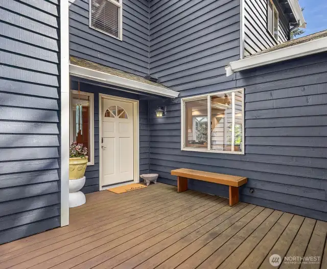 A charming wood porch welcomes you to the front entry. It's the perfect spot to greet guests.