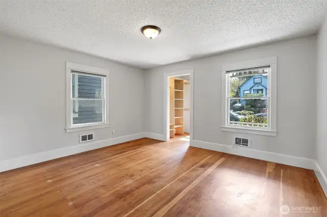Ground floor bedroom with fir floors and walk-in closet