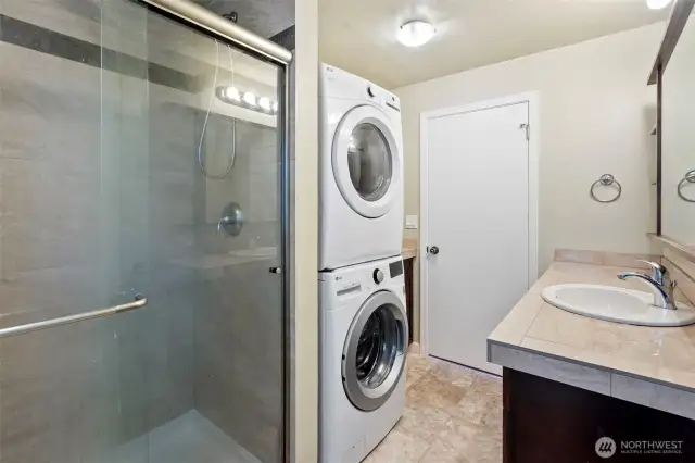 Ground floor bathroom with walk-in shower and stacked laundry units