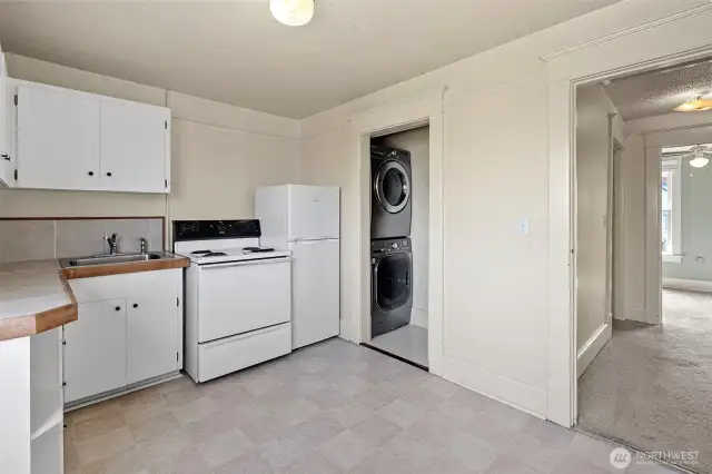 Upper unit kitchen with stacked laundry units