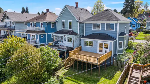 Rear facade with view deck off the ground floor unit